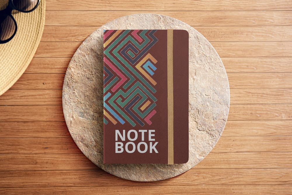 Note Book Mockup with Caput Mortuum Color on Podium