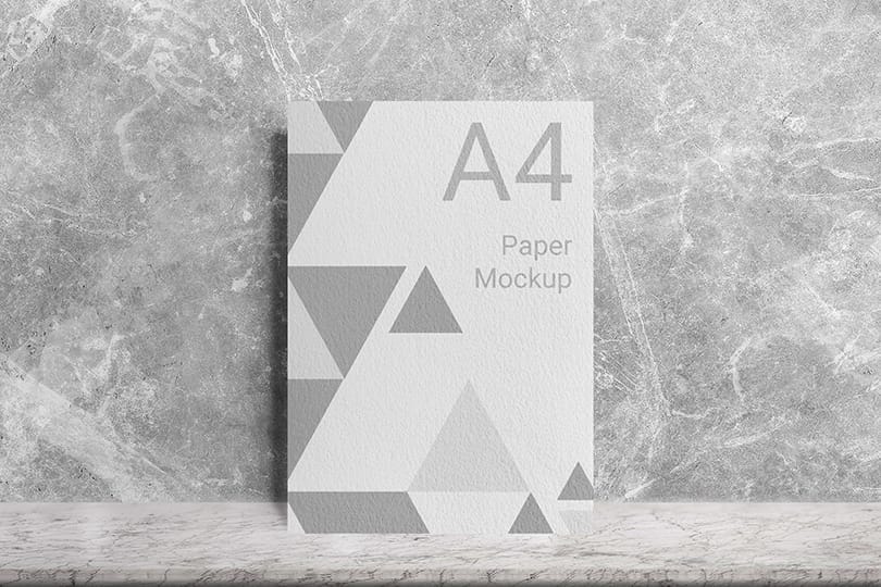 Realistic A4 Paper Mockup Lean On Cement Wall Background