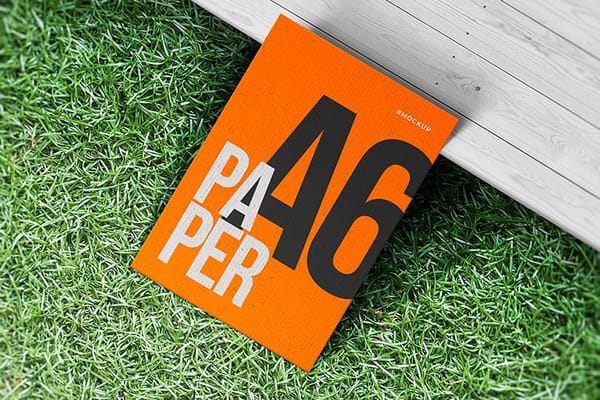Orange A6 Paper Mockup on Grass Ground